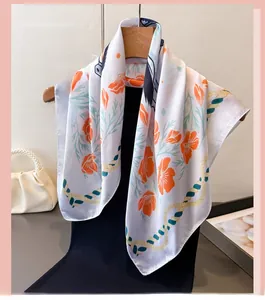 Detailed pattern of floral silk scarf featuring orange blossoms and rope texture detail
