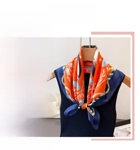 Detailed view of silk-like square scarf featuring equestrian horse and floral prints
