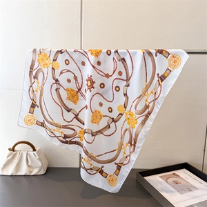 Detail of silk scarf showing vintage equestrian print with golden chains and belts