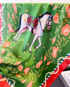 Detail of silk scarf showing vintage equestrian horse print and soft fabric texture