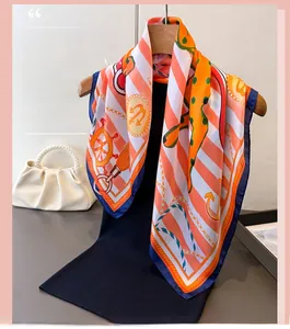 Detailed close-up of nautical anchors and chain prints on a luxury silk-like scarf