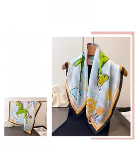 Detail of silk scarf with nautical anchors and green Dala horse print on blue stripes