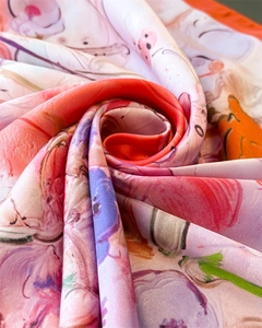 Macro shot of abstract floral print silk scarf with satin luster in twisted spiral shape