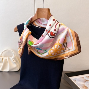 Silk scarf with nautical prints of helms and chains tied on a sleeveless top