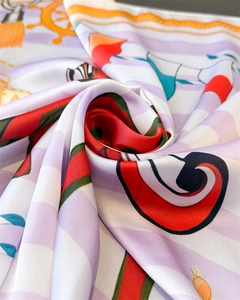 Detail of nautical print silk scarf featuring anchor motifs and spiraled fabric texture