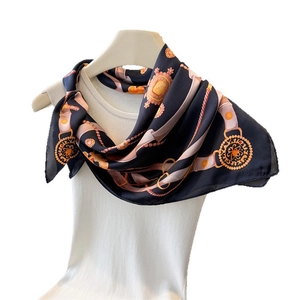 Navy silk square scarf with gold chain and buckle print on white vest and hanger