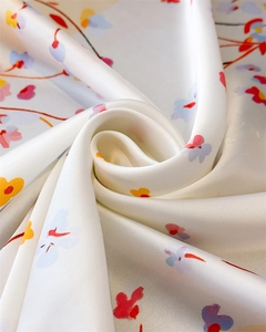 Macro shot of satin silk fabric with elegant floral print and smooth glossy texture