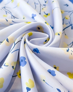 Detailed view of floral silk scarf fabric showing smooth texture and drape
