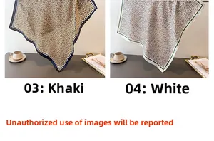 Detail of leopard print silk scarves in khaki and white colors with hemmed edges