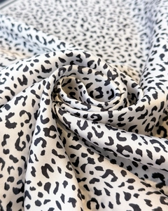 Detail shot of leopard print silk scarf showing soft folds and smooth satin texture