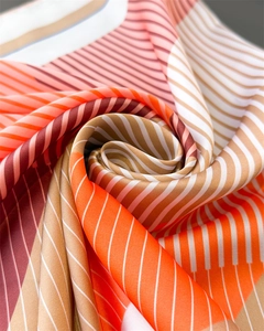 Macro shot of geometric striped silk scarf with elegant satin luster and draped swirl texture