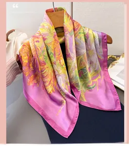 Detail view of abstract floral printed silk scarf hanging on a wooden hanger