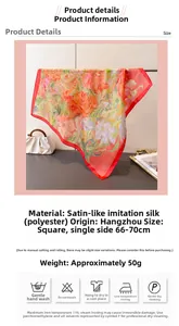 Close-up of printed satin silk scarf with colorful floral patterns and washing instructions