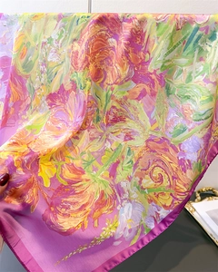 Detailed macro view of vibrant abstract floral print silk satin scarf with pink edges