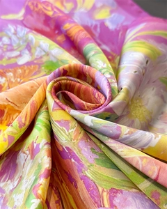 Detailed macro shot of silky satin fabric with vibrant floral print and elegant glossy finish