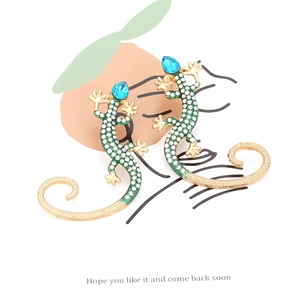 Vintage lizard stud earrings with colorful crystals and blue gemstone on display card