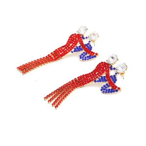 Abstract character earrings with red and blue rhinestones on a gold setting