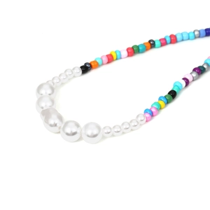 Bohemian colorful beaded necklace with gradient white pearls on white background