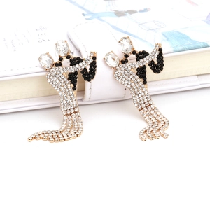 Detail of luxury rhinestone tassel earrings showing dancing couple motif in gold and crystals