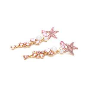 Detail of pink crystal starfish earrings with pearls and long gold tassel drops