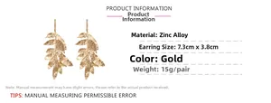 Detailed view of gold leaf fringe earrings showing size 7.3cm by 3.8cm dimensions