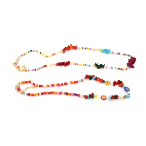 Detail of bohemian layered beaded necklace with colorful stones and flower beads