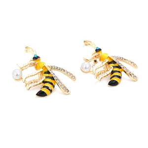 Enamel bee stud earrings with gold alloy, crystals and faux pearls on white background