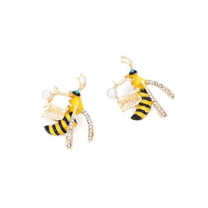 Detail of bee stud earrings with yellow enamel, sparkling crystals, and small white pearls