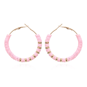 Detail of pink Heishi clay beads and gold metal spacers on large bohemian hoop earrings