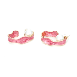 Detail of gold C-shape enamel earring with pink marble texture and a large pearl