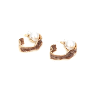 Detail of C-shaped gold-tone hoops with brown marble texture and pearl accents