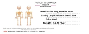 Detailed view of gold skeleton drop earrings with pearl accents and sizing dimensions