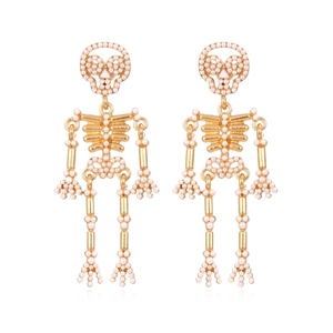 Golden skeleton earrings with white pearl accents in a gothic halloween style for women