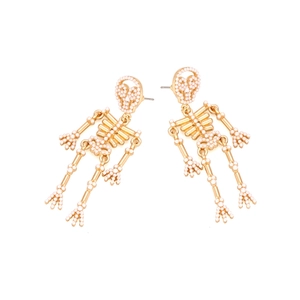 Gothic gold alloy skeleton drop earrings with white pearl accents on white background