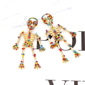 Boucles d'oreilles squelette avec cristaux colorés et articulations en or fini