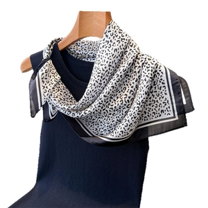 Leopard print silk satin square scarf paired with a black knitted sleeveless top