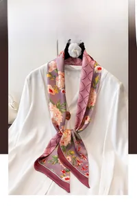 Detailed view of floral and geometric patchwork silk scarf tied on white shirt collar