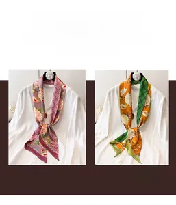 Close-up of floral silk scarves in purple-pink and orange-green with geometric patterns