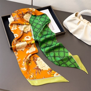 Elegant two-sided floral and geometric silk scarf styled with a luxury pearl handle handbag