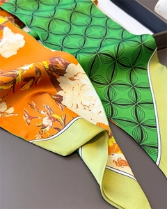 Detail of double-sided silk scarf with floral patterns and geometric prints