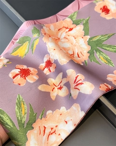 Close-up of lightweight silk-like scarf featuring elegant floral patterns and smooth texture