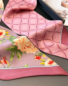 Close-up of pink geometric and purple floral silk scarves with contrast piped edges