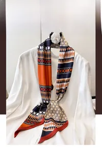 Close-up of geometric ethnic print scarf in orange and black on a white shirt