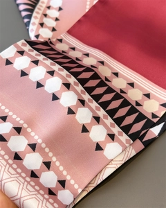 Macro detail of silk scarf with geometric hexagonal patterns and satin finish