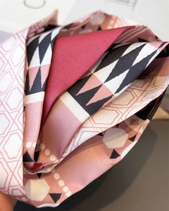 Close-up of geometric pattern silk scarf showing soft fabric texture and satin luster