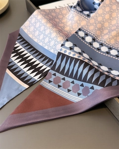 Detailed view of geometric pattern silk scarf with satin luster and mosaic hexagon motifs