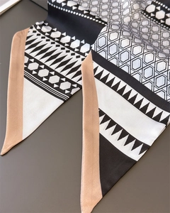 Detail of elegant geometric pattern silk scarf with black white honeycomb texture