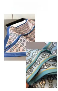 Detail of vintage geometric silk scarves in pastel blue and pink with neat edge stitching