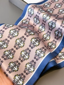 Detail of silk texture scarf showing vintage totem print and blue contrast border