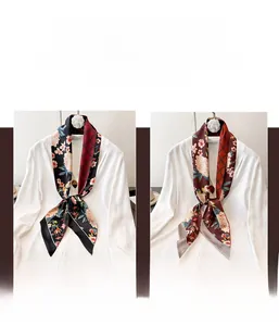 Dettaglio di sciarpe sottili in seta a fiori su camicia bianca in nero e bordeaux